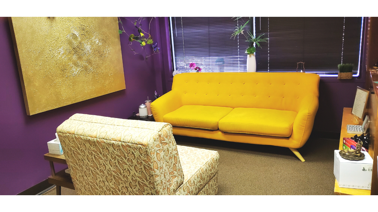 calm office space for spiritual healing with bright sofas in gold yellow and purple