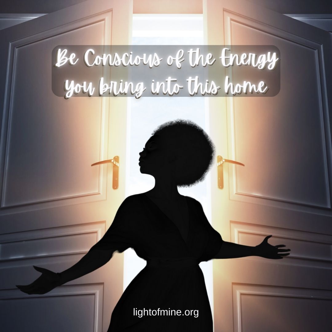 a silhouette of a women in front of a partly open door with light pouring out of it