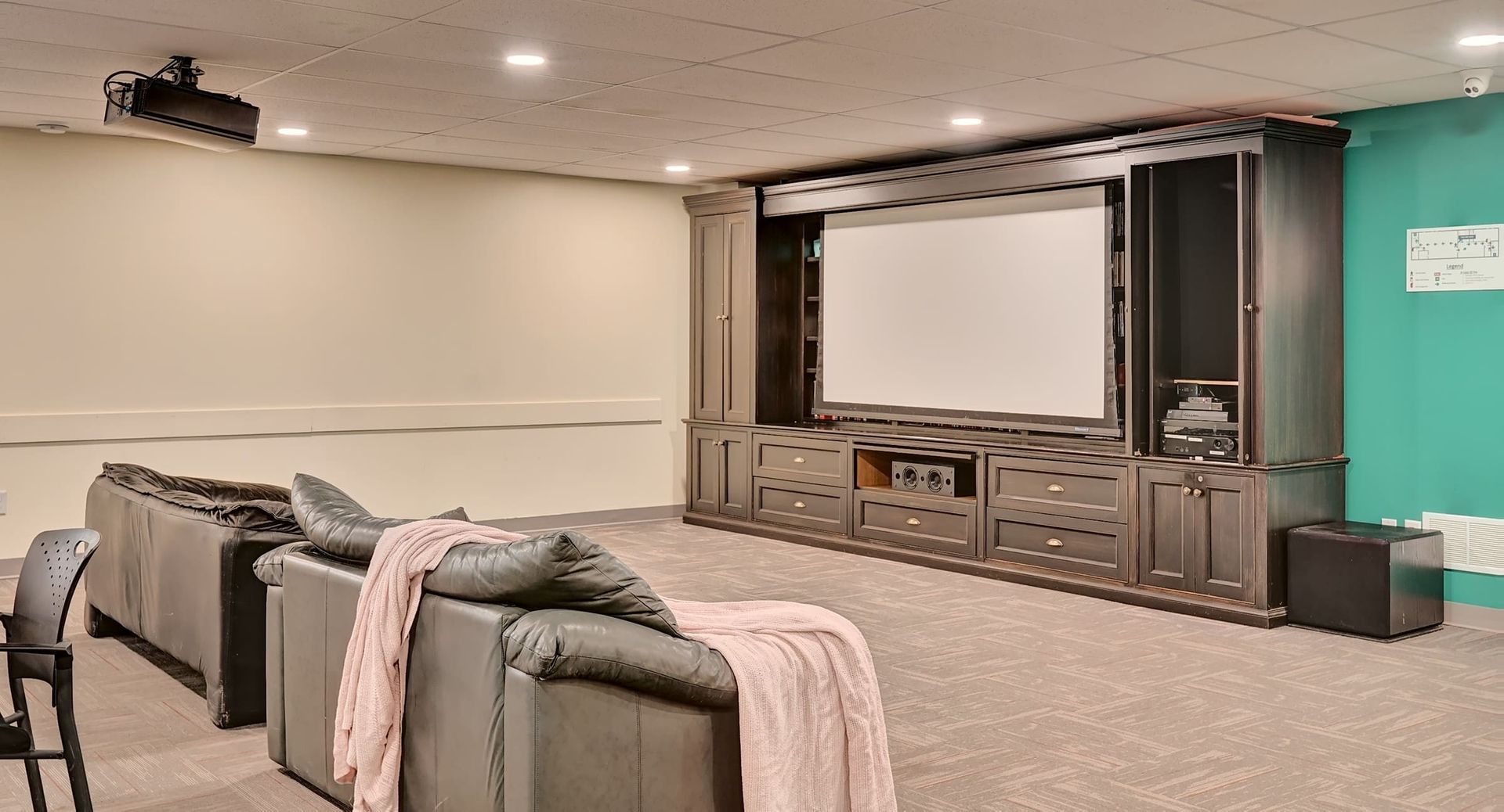 a home theater with a large projector screen