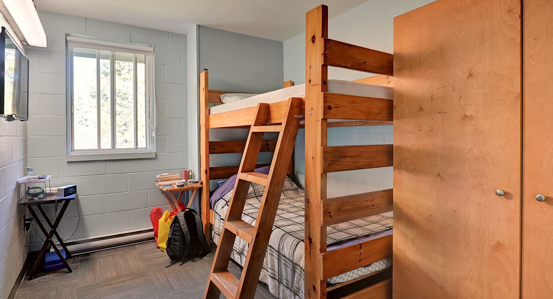 a bunk bed with a ladder in a small room