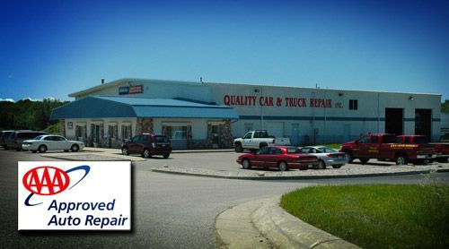 Quality Car & Truck Repair building with cars parked outside, AAA Approved Auto Repair logo. | Quality Car & Truck Repair Inc