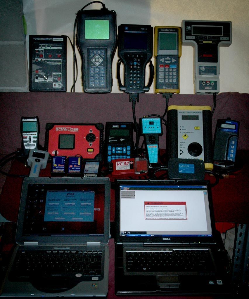 Collection of electronic devices: laptops, handheld scanners, and diagnostic tools. |  Quality Car & Truck Repair Inc