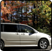 Silver minivan parked with autumn foliage in background.  |  Quality Car & Truck Repair Inc