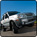 White SUV with a raised front wheel, on paved road, blue sky.  |  Quality Car & Truck Repair Inc