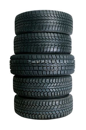 Stack of six black tires. | Quality Car & Truck Repair Inc