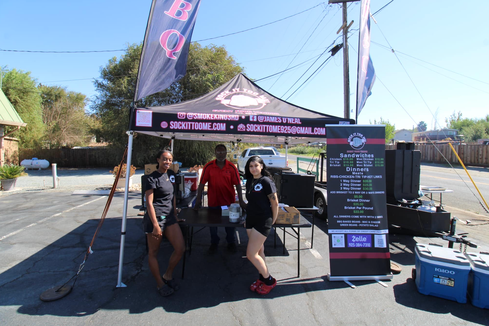 A group of people standing in front of a tent that says ' a ' on it