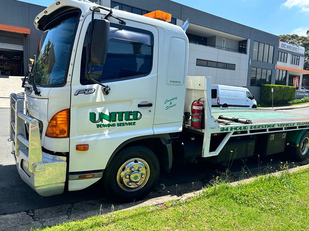 Tilt Body Tow Truck Loads a Panel Van — Sydney, NSW — United Towing Services Pty Ltd