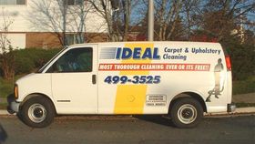 an ideal carpet and upholstery cleaning van is parked on the side of the road