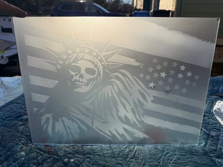 Votive candle holder with a frosted Statue of Liberty and U.S. flag design on a glass block