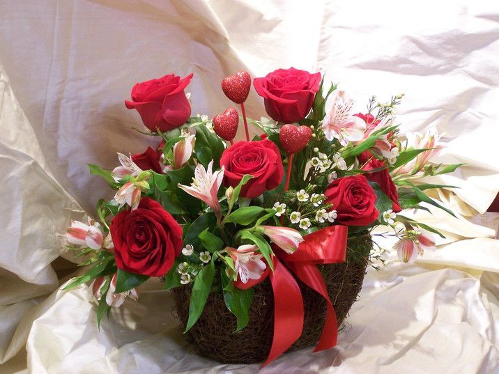 A basket filled with red roses and white flowers