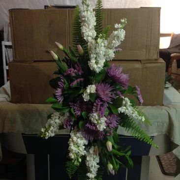 A bouquet of purple and white flowers is sitting on a table.