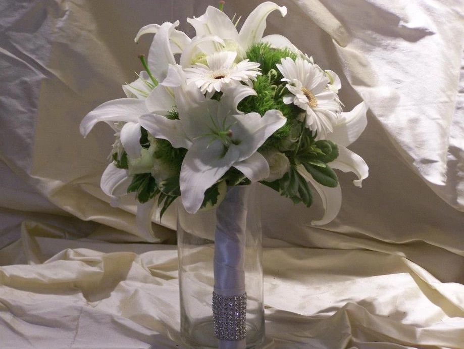 A bouquet of white flowers in a clear vase