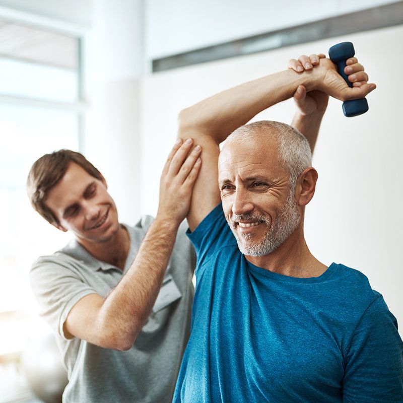 A doctor is examining a patient 's leg and knee