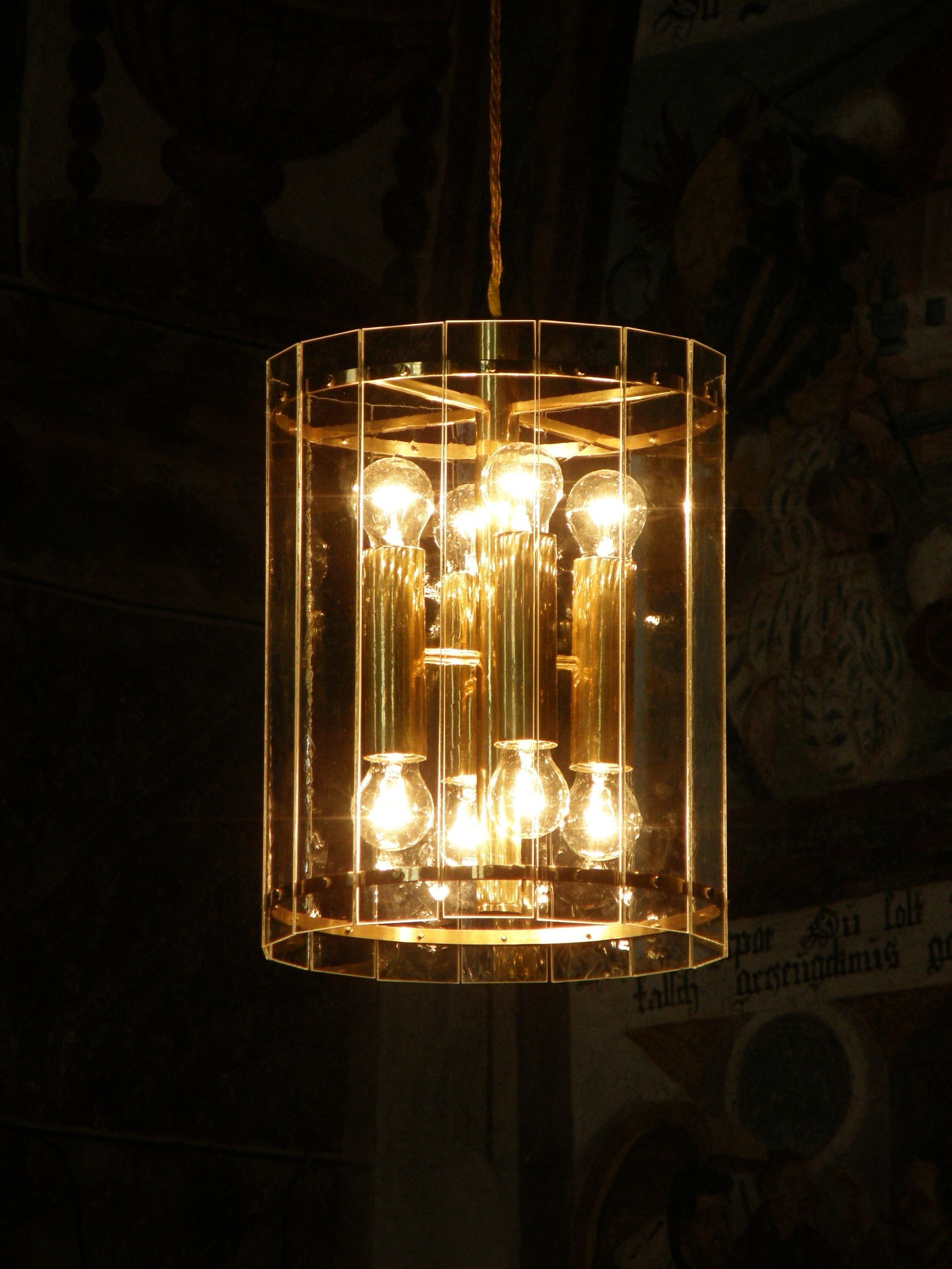 eine Lampe hängt an einer Kette in einem dunklen Raum