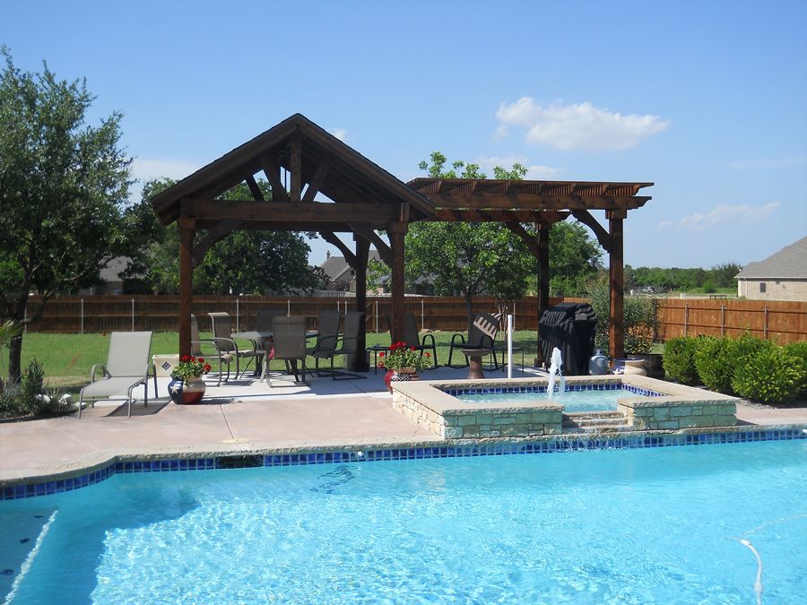 A large swimming pool with a pergola over it