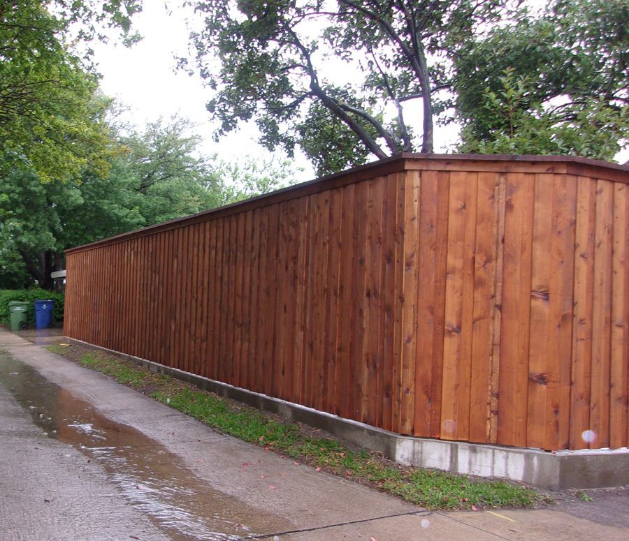 A wooden fence along the side of a road
