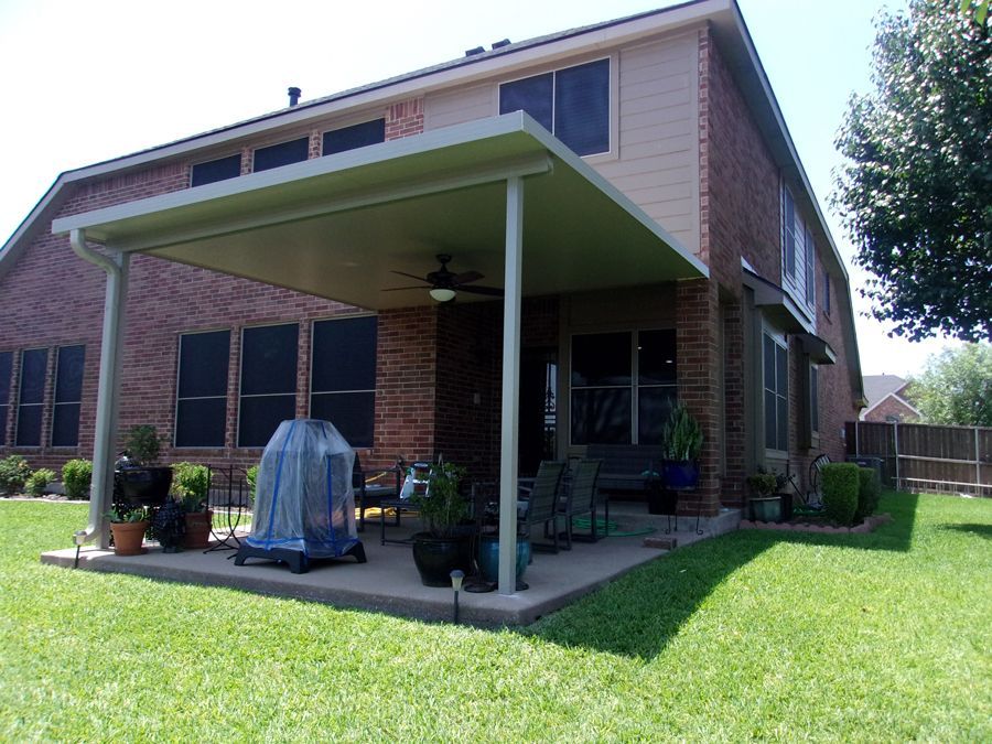 A house with a covered patio in the backyard