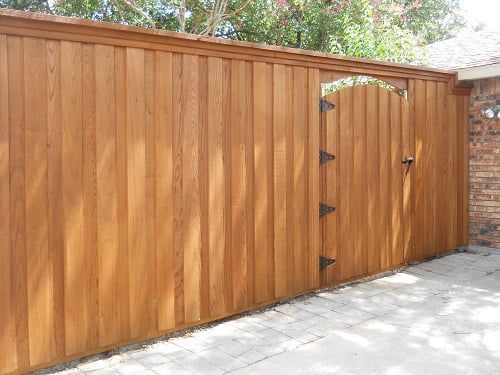 A wooden fence with a gate attached to it.