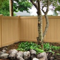 A wooden fence with a tree in the middle of it.