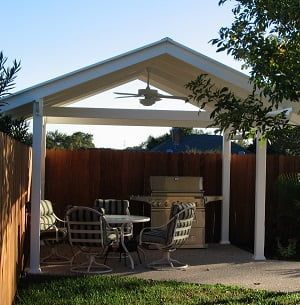 A gazebo with a table and chairs underneath it