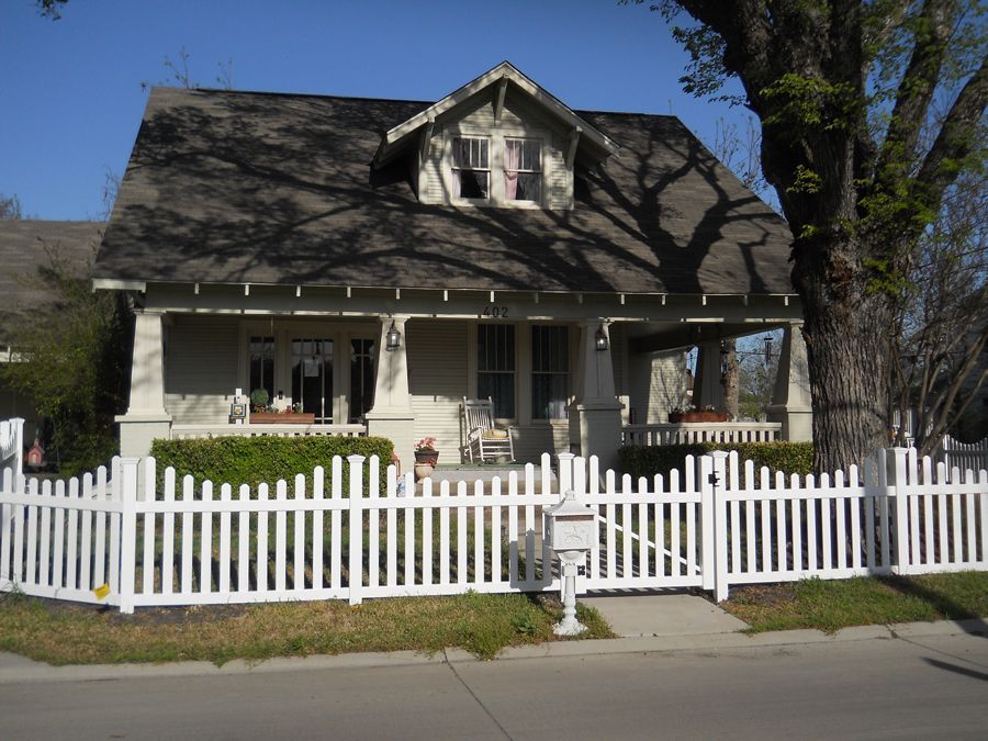 A house with a white picket fence around it