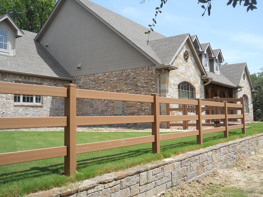 A house with a wooden fence in front of it
