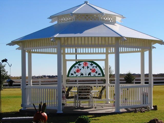 A white gazebo with a stained glass window