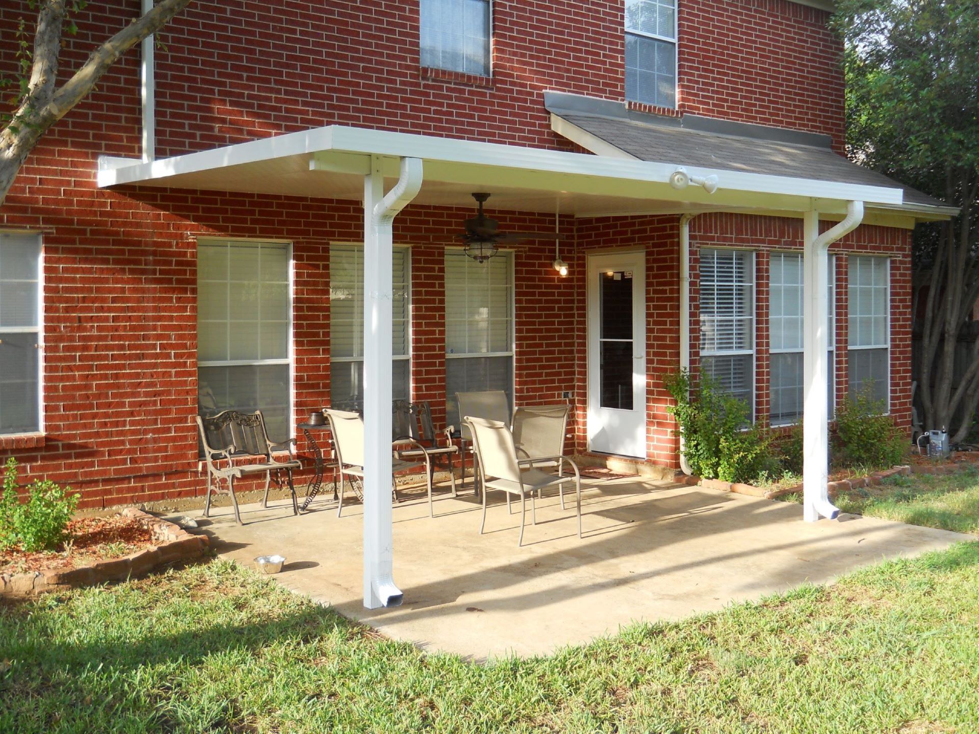 A patio with a table and chairs under a pergola