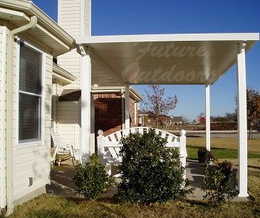 A white house with a white bench under a canopy that says future outdoor