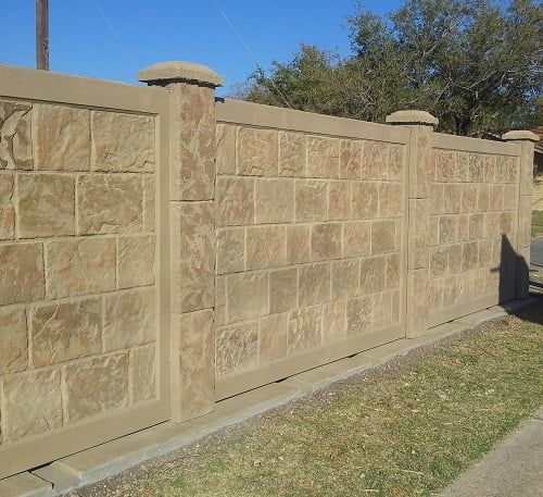 A stone fence with a blue sky in the background