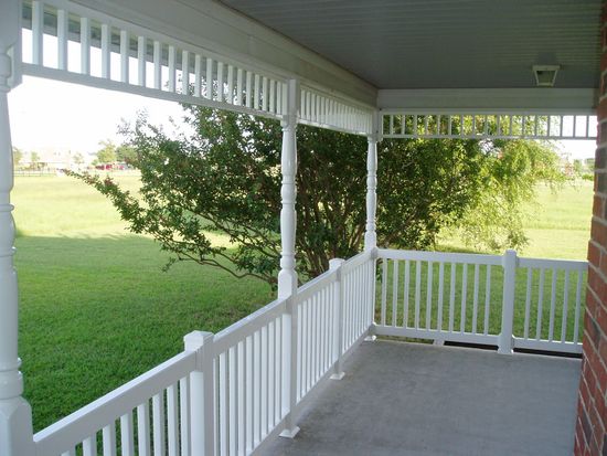 The inside of a church with rows of benches and a large window.