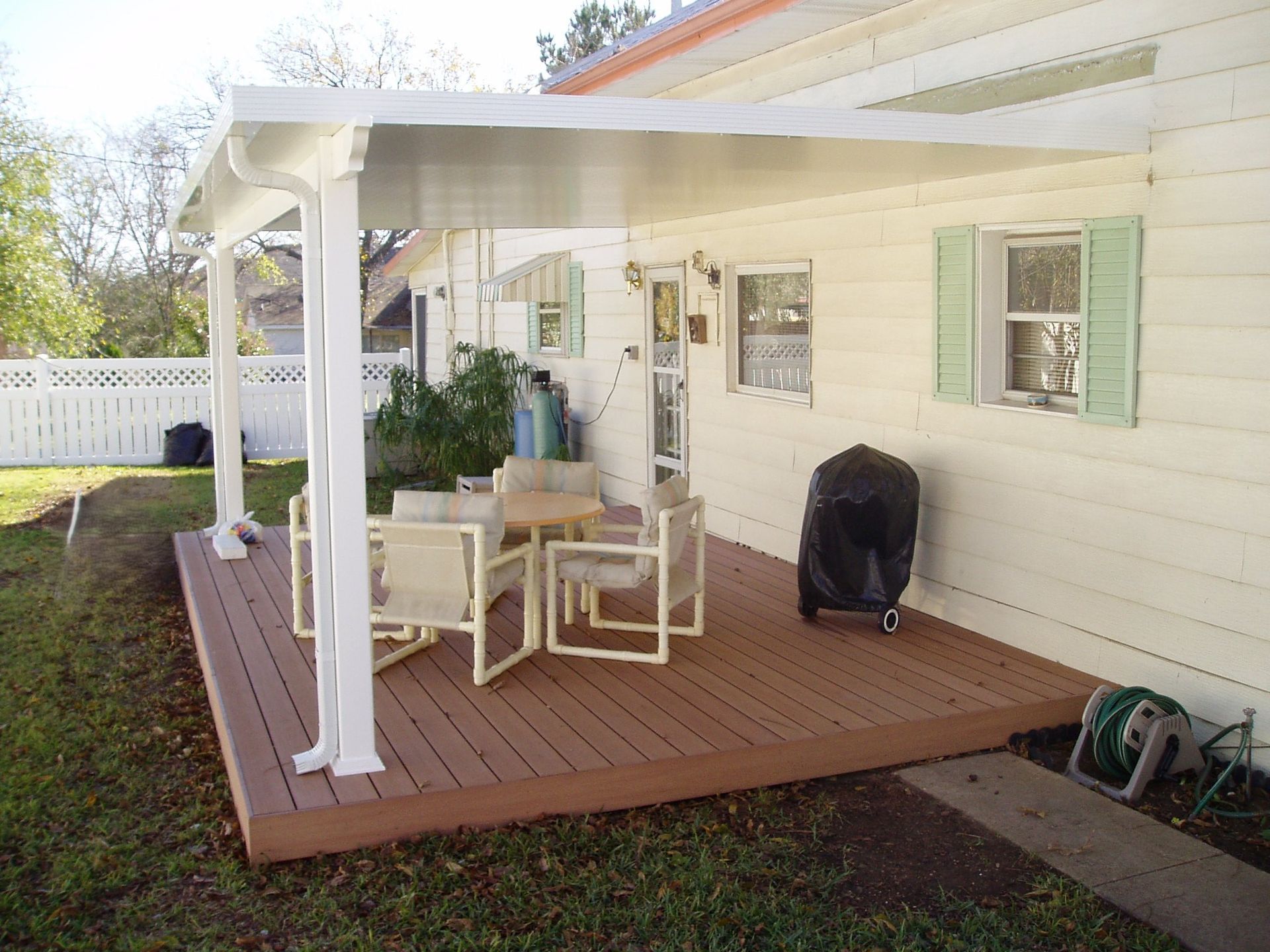 A wooden deck with a table and chairs on it