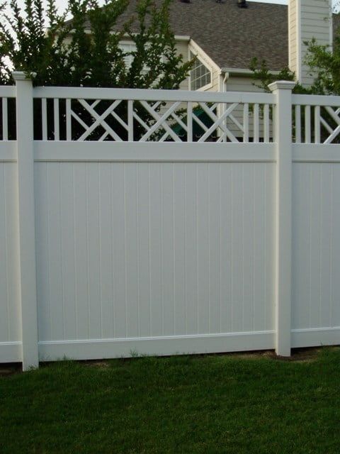 A white fence with a house in the background