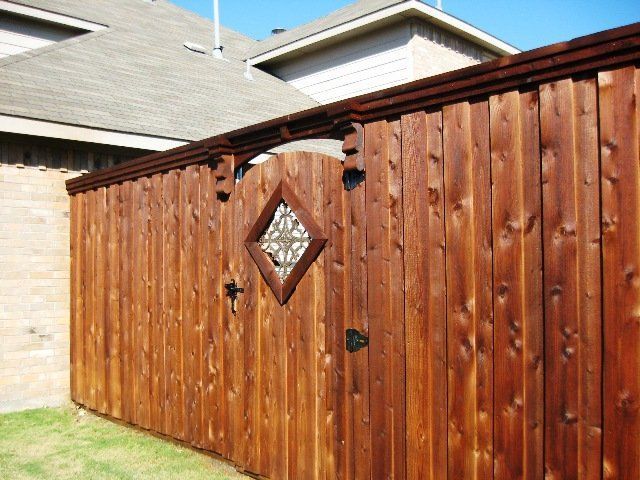 A wooden fence with a diamond shaped gate