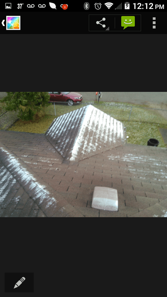 A phone screen shows a picture of a pyramid on a roof.