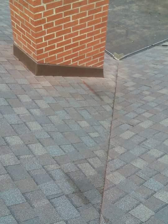 A brick chimney is sitting on top of a brick floor.