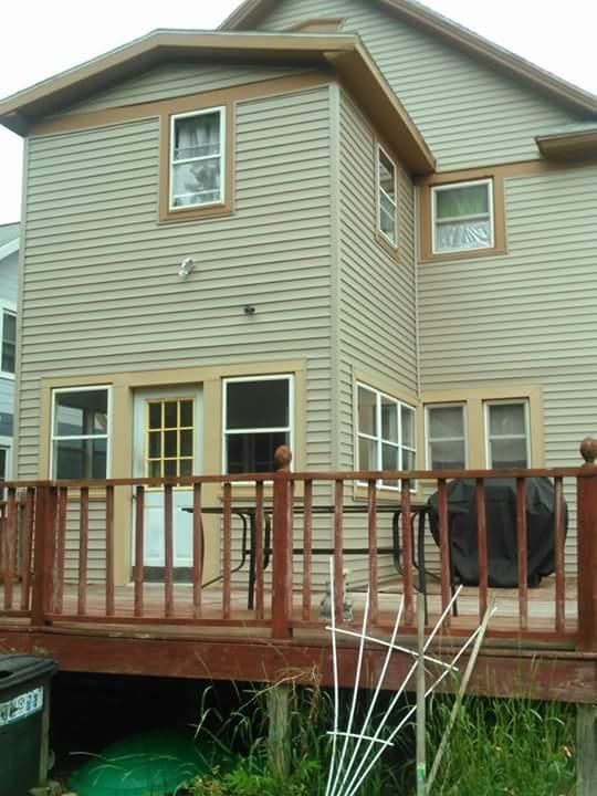 The back of a house with a wooden deck