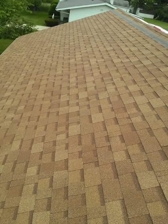The roof of a house has a lot of shingles on it.