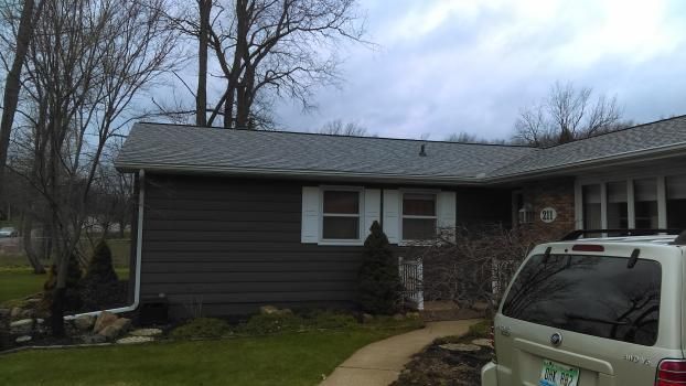 A car is parked in front of a house.