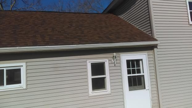A house with a brown roof and a white door