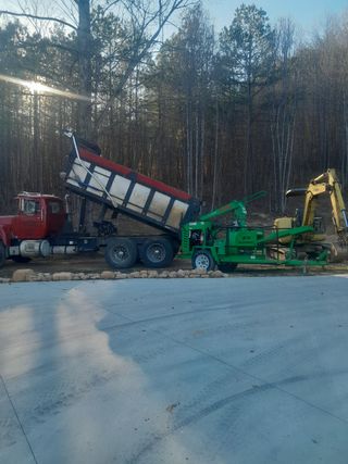 An aerial view of a yellow excavator working on a construction site.