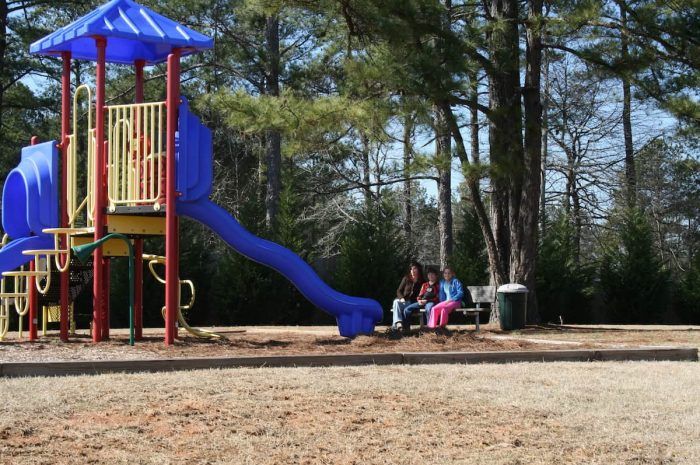 Meadow Trace - Playground with family sitting on a bench