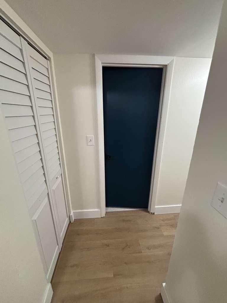 A hallway with a blue door