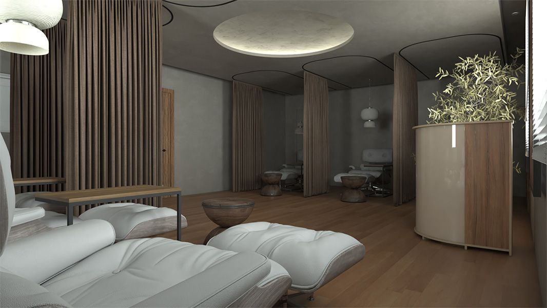 A calm spa interior with a white lounge chair, privacy curtains separating treatment areas, and soft ambient lighting.