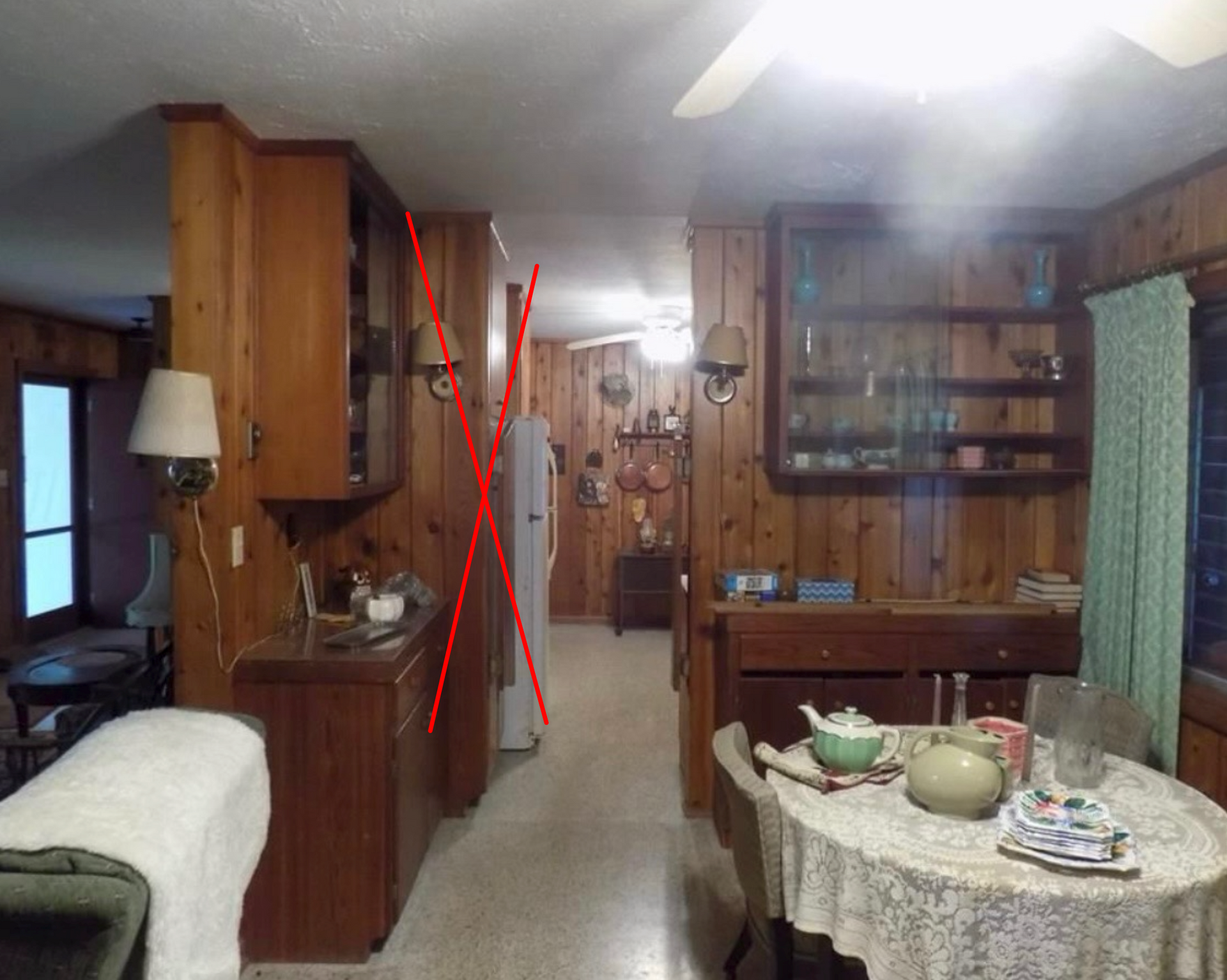 Kitchen with wood paneling, cabinets, and dining table. Red lines highlight perspective and structure.