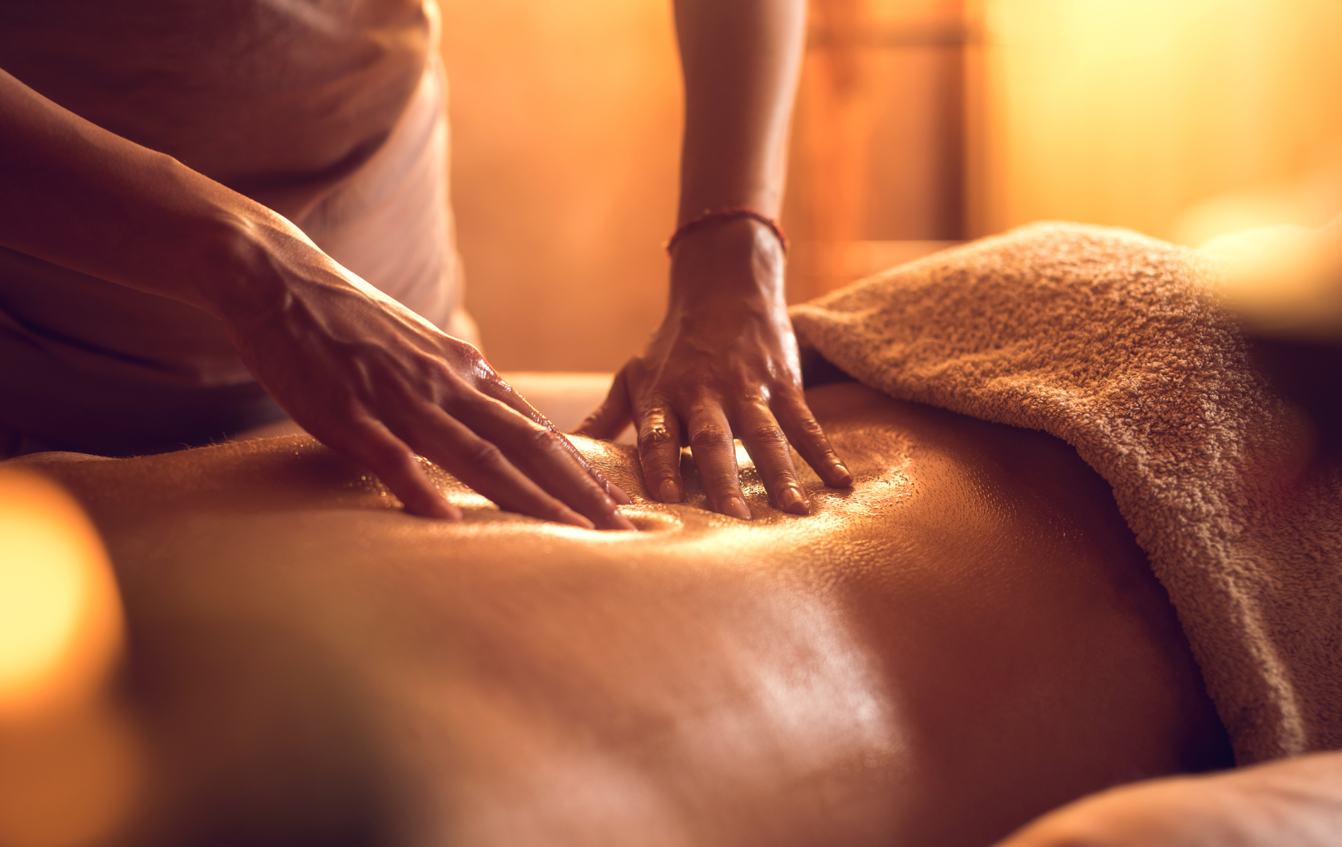 A woman is giving a man a massage in a spa.