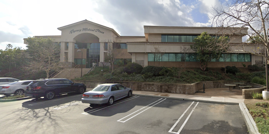 A large building with cars parked in front of it