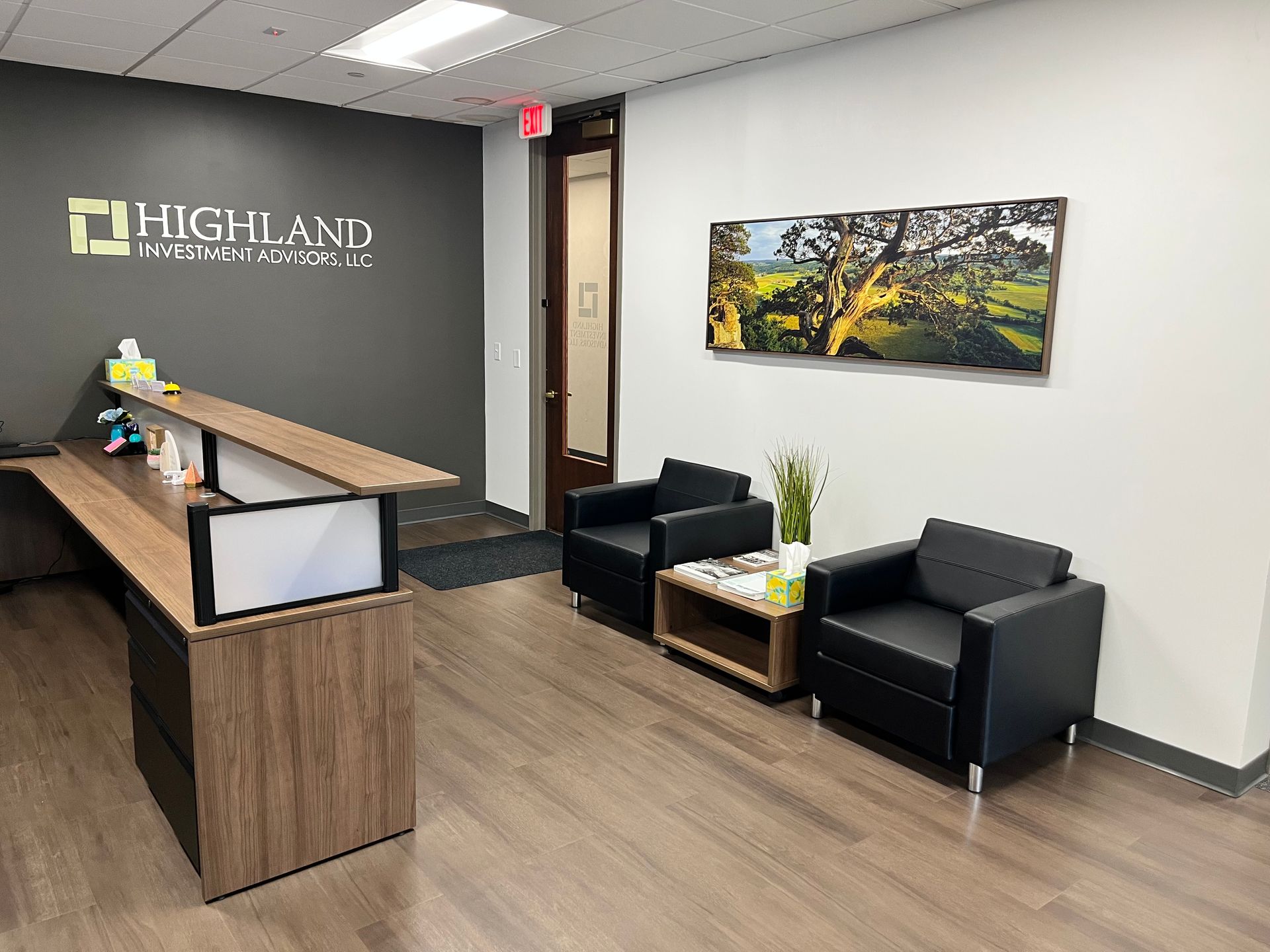 Two people are walking down a dirt road in the woods.