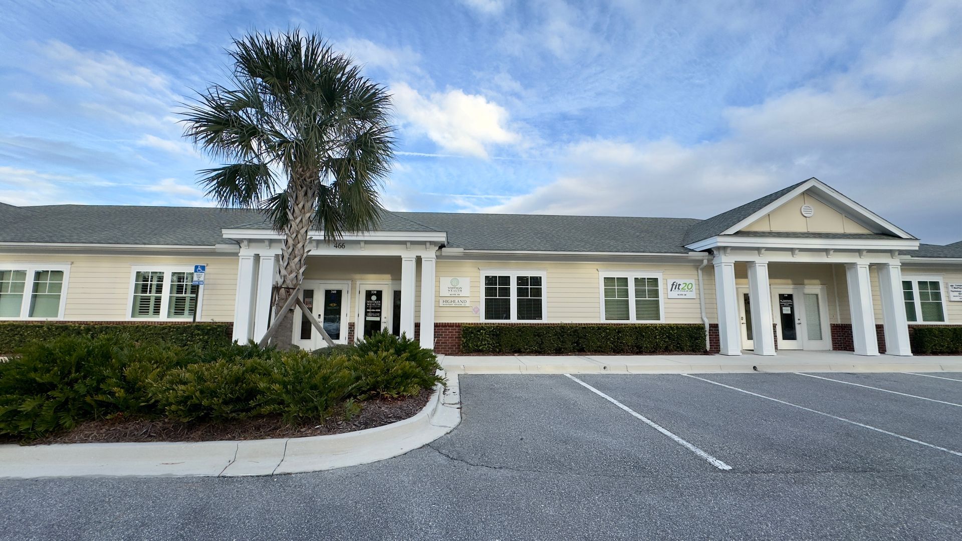 A large building with a parking lot in front of it