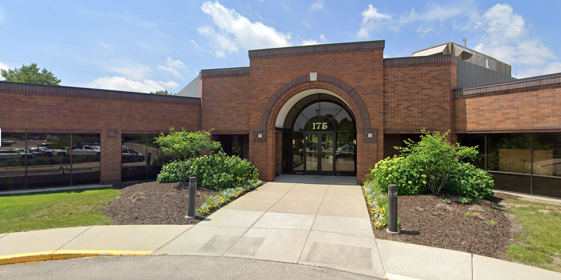 A large brick building with a walkway leading to the entrance.